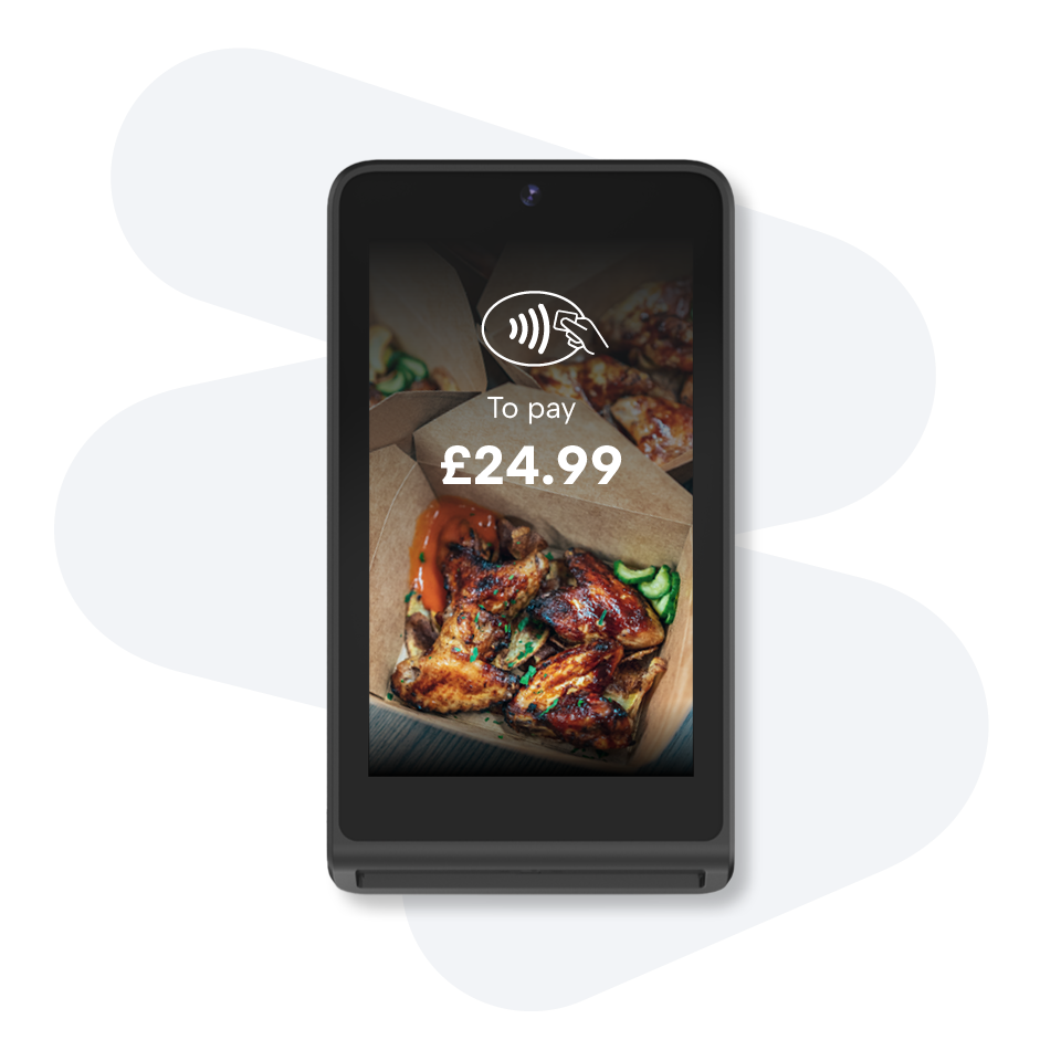 Contactless payment device displaying £24.99 for a meal with grilled chicken and vegetables in a cardboard box.